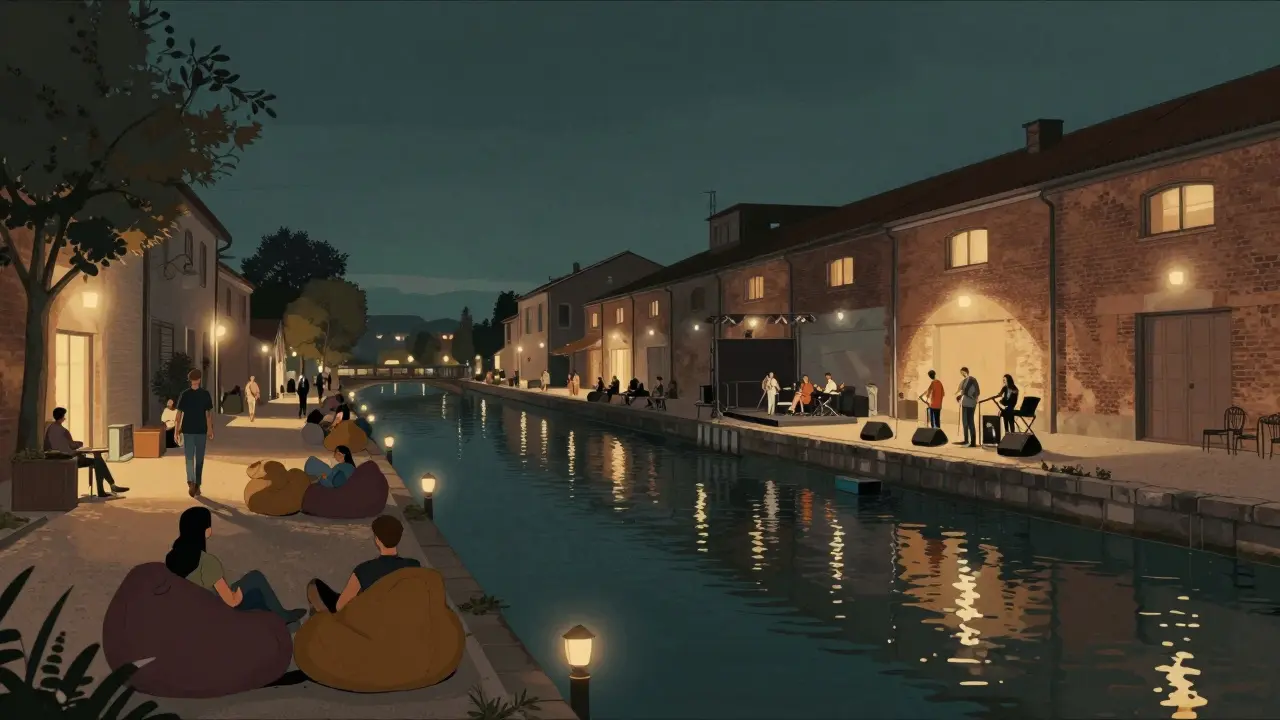 Nighttime scene along Naviglio Pavese canal with people relaxing by bars, lanterns reflecting on water.