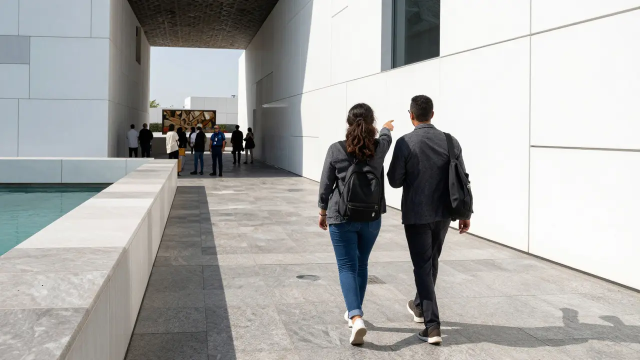 Two people walking near an art installation at Louvre Abu Dhabi's outdoor terrace, engaged in conversation.